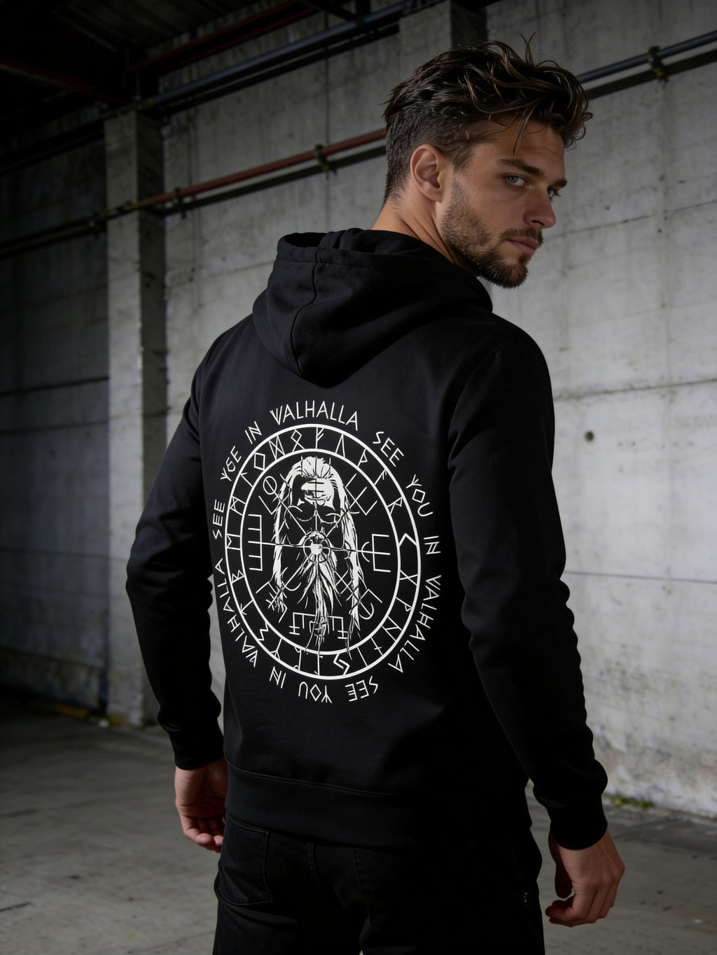 A man wearing a Valhalla Black Zipper Hoodie.