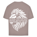 The Oversize Shirt Braves in taupe showcases a bold white lion head Löwen Backprint with "THE WORLD belongs to the BRAVES" emblazoned across it in striking, stylized lettering.